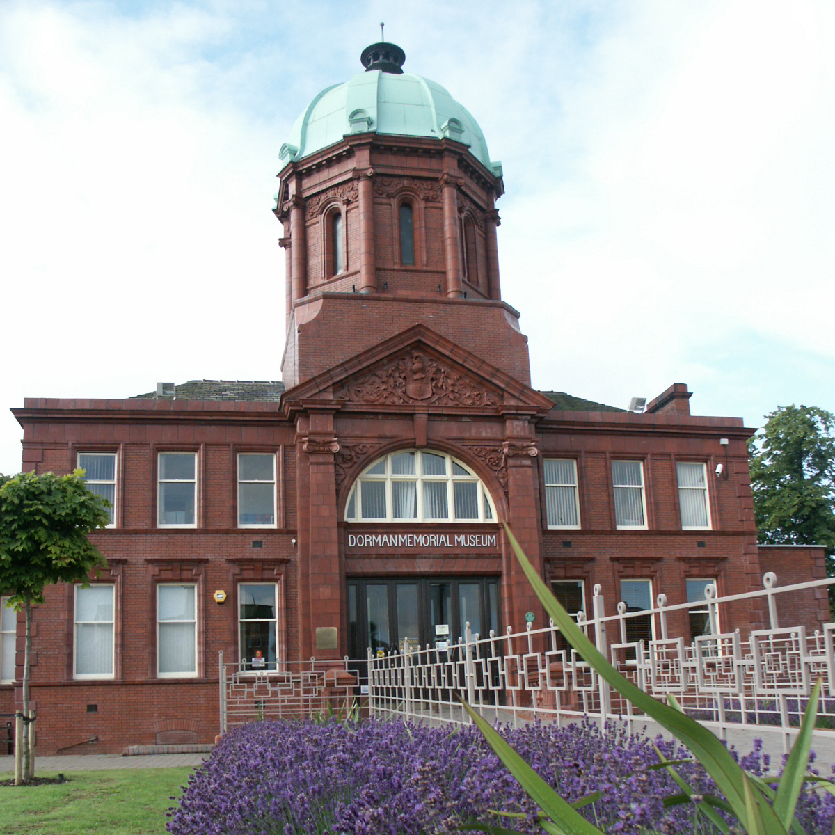 The exterior of the Dorman Museum including a domed tower above a grand arched entrance