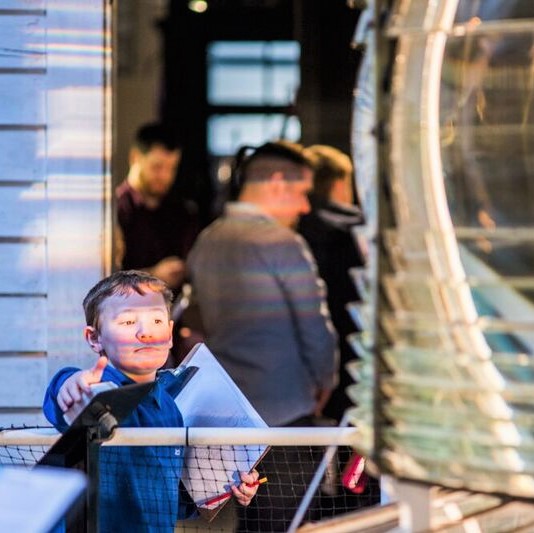 A child presses a button inside a museum